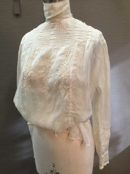 N/L, Cream, Silk, Solid, China Silk, High Collar Band with Lace Trim. Tuck Pleat Detail at Collarbone, Eyelet Lace Embroidery at Center Front, Hidden Button Closure Center Back, Inlayed Lace at Cuffs. Rayon Ribbon at Waisr, Long Sleeves, Collar in Fragile State Backed with Organza.hole at Collar Bone Left Front.  Hole at Left Cuff. Hole at Right Mid Sleeve.,