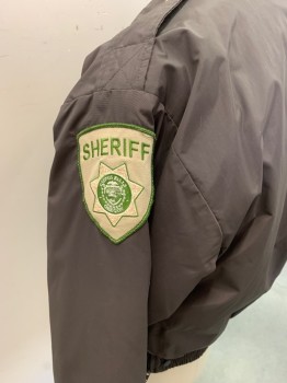 Mens, Fire/Police Jacket, FLYING CROSS, Dk Brown, Nylon, Polyester, Solid, L, Dark Brown with Light Khaki and Pea Green "Sheriff" Patch on Left Arm, USA Flag Patch on Right Arm, Zip Front, 4 Pockets with Gold Buttons on 2, Gold Button on Epaulettes, Elastic Cuffs and Waistband, Removable Liner with Barcode Written on Right Armscye