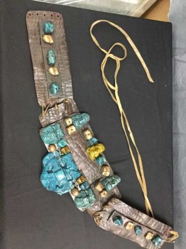 Unisex, Sci-Fi/Fantasy Belt, M.T.O., Dk Brown, Turmeric Yellow, Turquoise Blue, Gold, Leather, Fiberglass, Mayan Influenced Belt. Reptile Textured Brown Leather with Turquoise & Turmeric Skulls & Mayan God Headpieces Sculpted In Fiberglass/resin with Gold Painted Beads, Leather Wang Lacing At Center Back, Waist