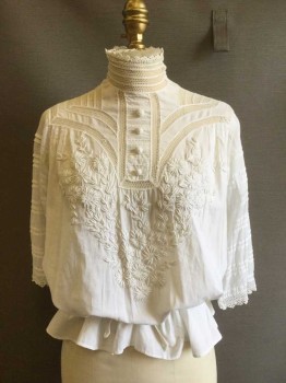 NL, White, Cotton, Solid, Floral, Upper Class Day Blouse. with Cotton Floral Embroidered Yoke Front. Honeycomb Lace Inlay at Yoke Front & Back. Tuck Pleats Front, Back & 3/4 Sleeves with Crochet Lace Trim, Crochet Buttons at Center Front, High Collar Band of Honeycomb Lace Crochet. Center Back Buttons. Twill Tape at Waist Back.  Condition Very Good Except for Repair Under Right Arm. Some Repair at Neckline Front & Back,