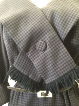 GIORGETTE TRILERE, Black, Brown, Wool, Silk, Gingham, V. Neck with Shawl Collar with Button Down Tie and Black Yarn Trim. 3/4 Sleeves, Cuffed with Covered Button and Black Yarn Fringe. Side Zipper Closure at Skirt with Snap Closures at Bodice.WITH BELT Skinny Black Leather with Rectangular Shell Buckle