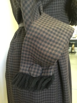 GIORGETTE TRILERE, Black, Brown, Wool, Silk, Gingham, V. Neck with Shawl Collar with Button Down Tie and Black Yarn Trim. 3/4 Sleeves, Cuffed with Covered Button and Black Yarn Fringe. Side Zipper Closure at Skirt with Snap Closures at Bodice.WITH BELT Skinny Black Leather with Rectangular Shell Buckle