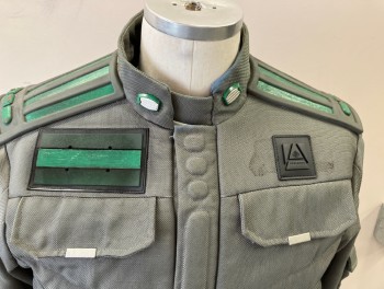 MTO, Gray, Green, Black, Nylon, Synthetic, Quilted Front, Zip/snap Front, Stand Collar, 2 Zip Pkts., Utility Pouch Pockets with Flaps - 2 In Front & 2 On Back, 2 Flaps On Chest (faux Pkts), 2 Self Belt Tabs At Front Waist, Zipper Pkts & Flap Pkts On Sleeves, Green & Gray Rubber Back Yoke, Black with Silver Metal Appliquéd Patches On Slvs,