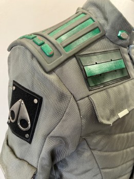 Mens, Jacket, MTO, Gray, Green, Black, Nylon, Synthetic, C42, Quilted Front, Zip/snap Front, Stand Collar, 2 Zip Pkts., Utility Pouch Pockets with Flaps - 2 In Front & 2 On Back, 2 Flaps On Chest (faux Pkts), 2 Self Belt Tabs At Front Waist, Zipper Pkts & Flap Pkts On Sleeves, Green & Gray Rubber Back Yoke, Black with Silver Metal Appliquéd Patches On Slvs,