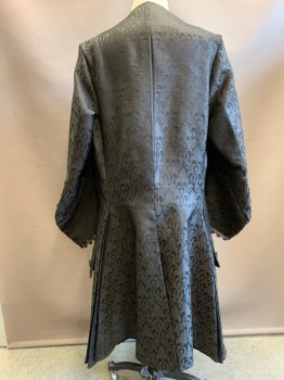 N/L MTO, Black, Polyester, Swirl , 1700's Made To Order, Brocade, Round Neck, Seed Beaded Trim at Front, Fabric Covered Buttons, 2 Pockets at Hips with Large Decorative Flaps, 3 Vents/Slits at Back Hem