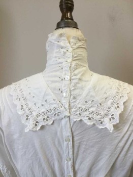 N./L, White, Cotton, Solid, Floral, Cotton Broadcloth Blouse with Eyelit Yoke with Sailor Like Collar & High Collar Band. Button Closure Center Back, Tuck Pleats at Shoulders Front and Back. Tuck Pleats at Mid Sleeve. Twill Tape at Waist Back. 3/4 Sleeves with Eyelit Lace Trim at Cuffs,