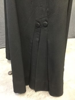 MTO, Black, Wool, Solid, Gaberdine Wool, Tuck Pleat Panel Detail at Front and Back of Skirt. Hidden Hook & Eye Closure Under Left Back Panel. Triple Inverted Pleat Detail at Side Seam Hemline with 2 Covered Button Detail on Left & Right Side. Hole Repair at Right Side Hemline,