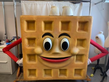 MTO, Tan Brown, Caramel Brown, Foam, Latex, Novelty Pattern, Waffle!, Cute Cartoon Walkabout, Aluminum Box Frame, Thick Foam, Enter Through the Back, 2 Leg Holes, Velcro Attached Back Panel, Top Lip Has a Wiggle Handle Inside. Dimensions 93" Arm to Arm X 49" Tall  X 19" Deep